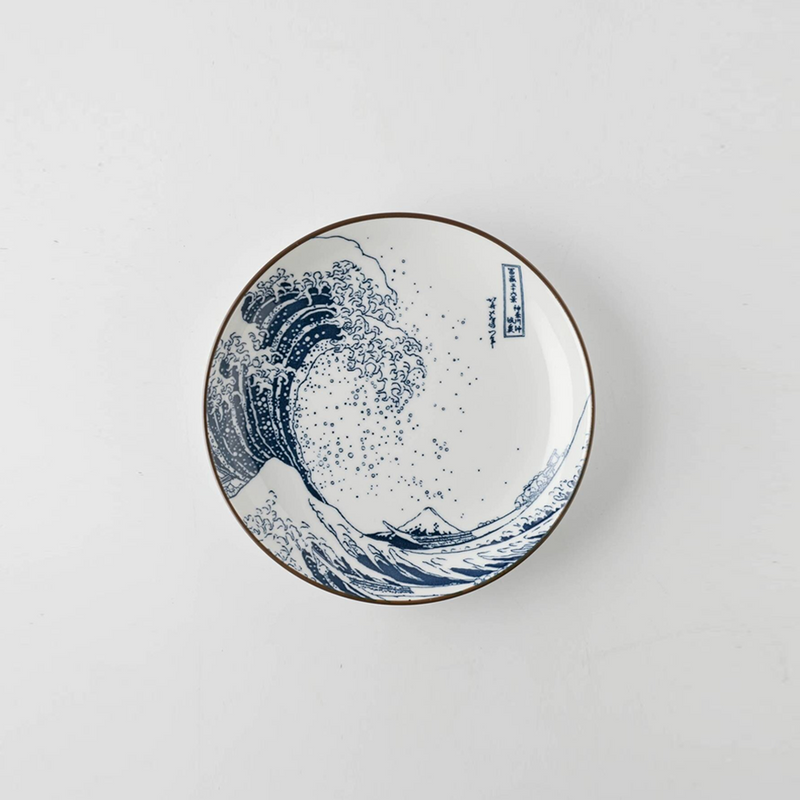 A 15.5cm porcelain plate with a blue and white Great Wave off Kanagawa pattern on a white background.