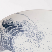 Ceramic plate with blue wave design on a white background