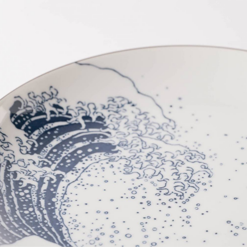 Ceramic plate with blue wave design on a white background