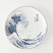 A close-up detail shot of the Hokusai artwork on the plate, showing the fine blue lines and dots of 'The Great Wave' print.