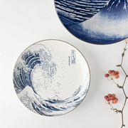 A top-down studio shot of the Showa Seito 'The Great Wave' plate, showing the complete Hokusai artwork on its surface.