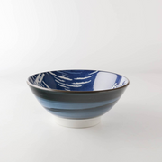 A side view of the Showa Seito Mount Fuji Soba Bowl, showing its swirling blue exterior glaze and tall white base.
