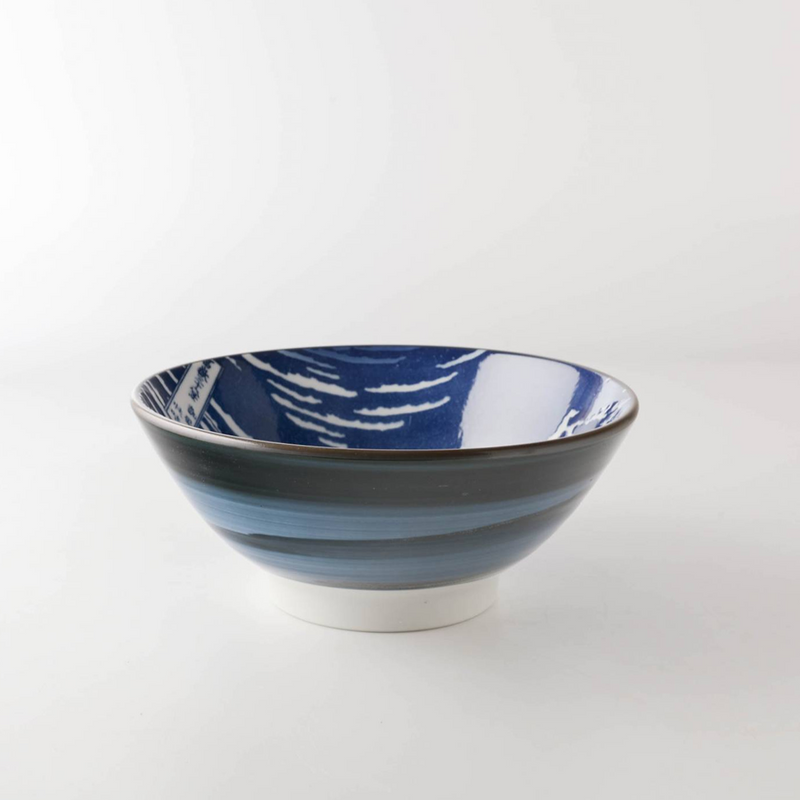 A side view of the Showa Seito Mount Fuji Soba Bowl, showing its swirling blue exterior glaze and tall white base.
