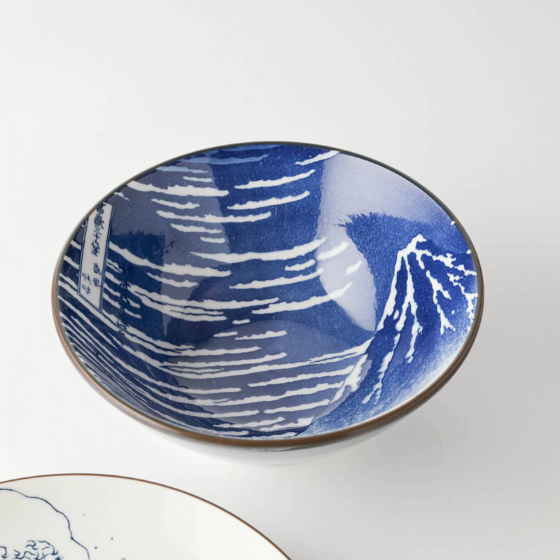 The Showa Seito Mount Fuji Soba Bowl filled with a donburi meal, shown on a black placemat with chopsticks.
