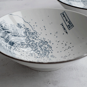 A close-up detail shot of the interior of 'The Great Wave' ramen bowl, showing the fine blue lines of the ukiyo-e print and the artist's cartouche.







