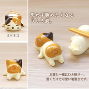 unlife Nemunemu Calico Cat Chopstick Rest shown from various angles, highlighting its hand-painted details, cozy curled tail, and practical use for elevating chopsticks.