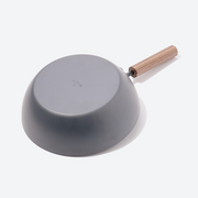 Tanabe Kanagu Nitrided Carbon Steel Wok 26cm, showing the bottom surface of the wok with a wooden handle