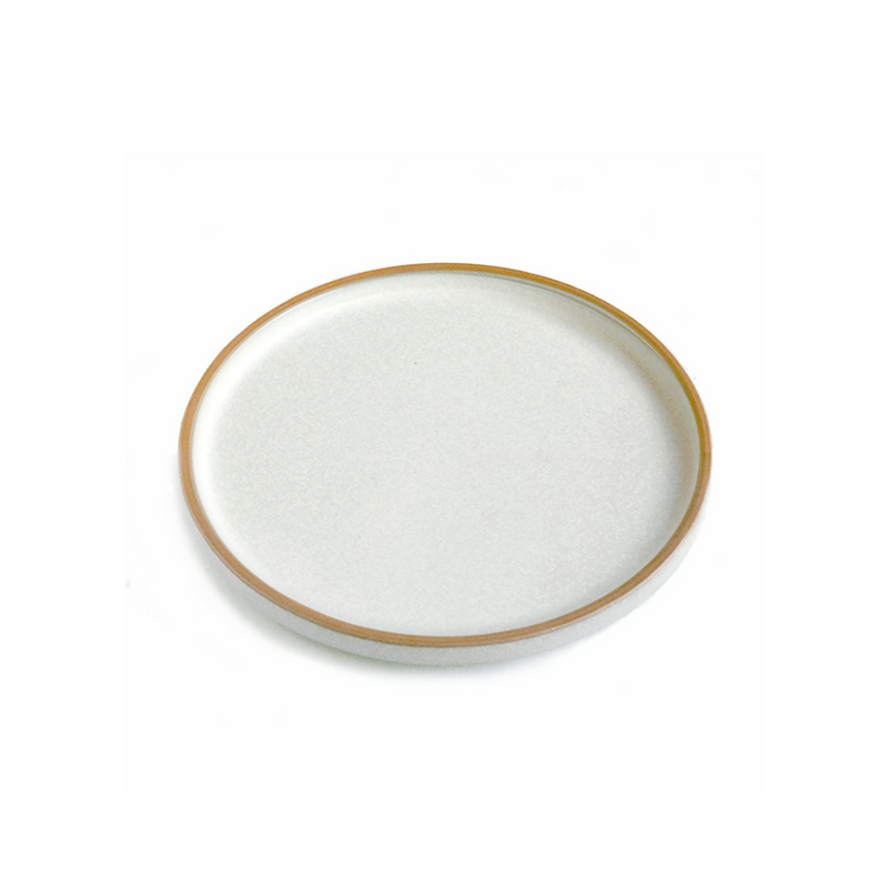 A single dinner plate from the Tojiki Tonya Cocochi Series in white. The plate features a clean, smooth surface with a subtle brown rim, embodying the series’ minimalist and timeless design.