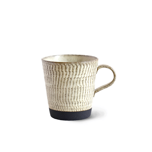 A close-up of the Tojiki Tonya Kanna Series Mug in Ivory, featuring a textured surface and a smooth, rounded handle.