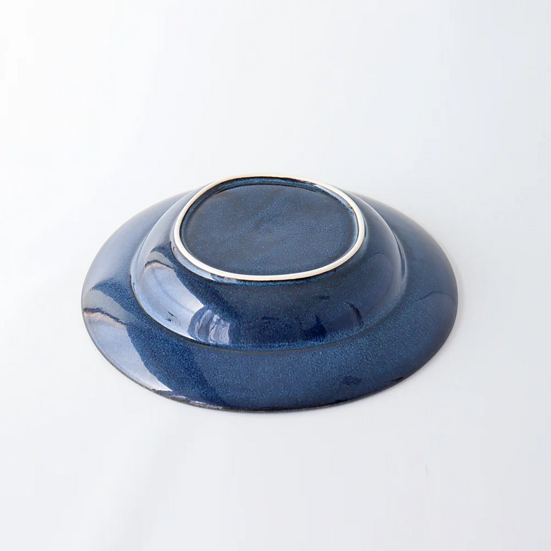 The underside of a Tojiki Tonya Orlo Series Pasta Plate, 24cm, showing the deep blue finish with a smooth, slightly raised base.
