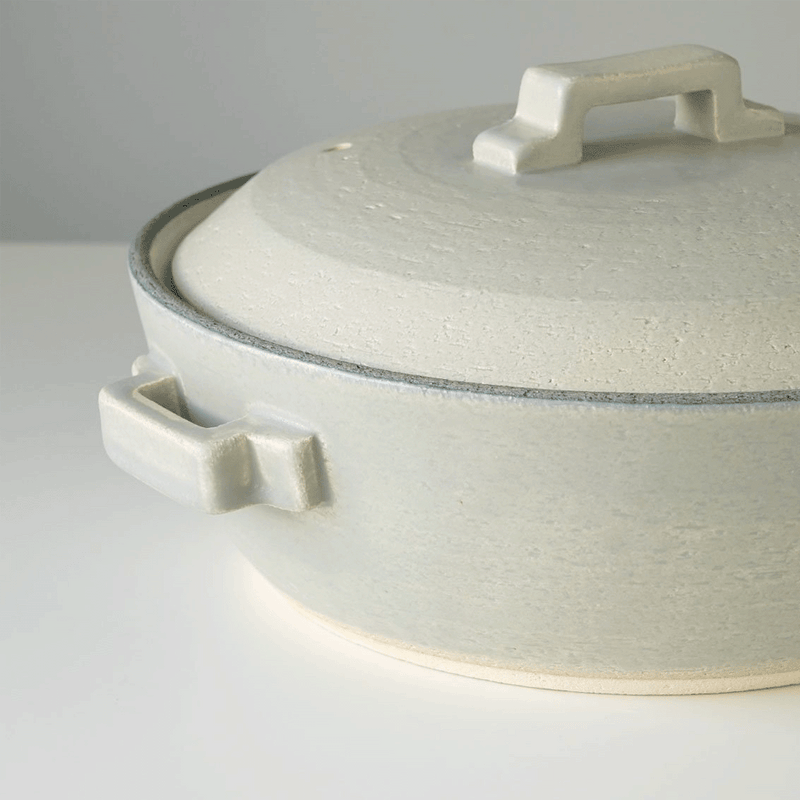 Bird's-eye view of the Tojiki Tonya Tstyle Donabe Japanese clay pot, emphasizing its smooth, silver-grey surface and central lid handle.