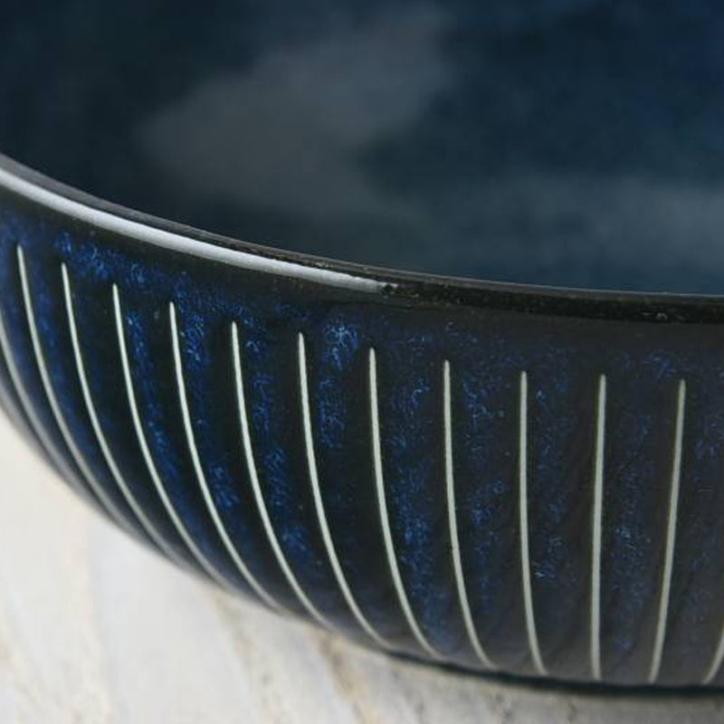 Close-up detail of the speckled indigo glaze and white Tokusa stripes on the Toki Takane bowl
