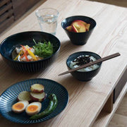 A Japanese meal set on a wooden table using the Toki Takane Indigo Tokusa collection, including the 20cm bowl