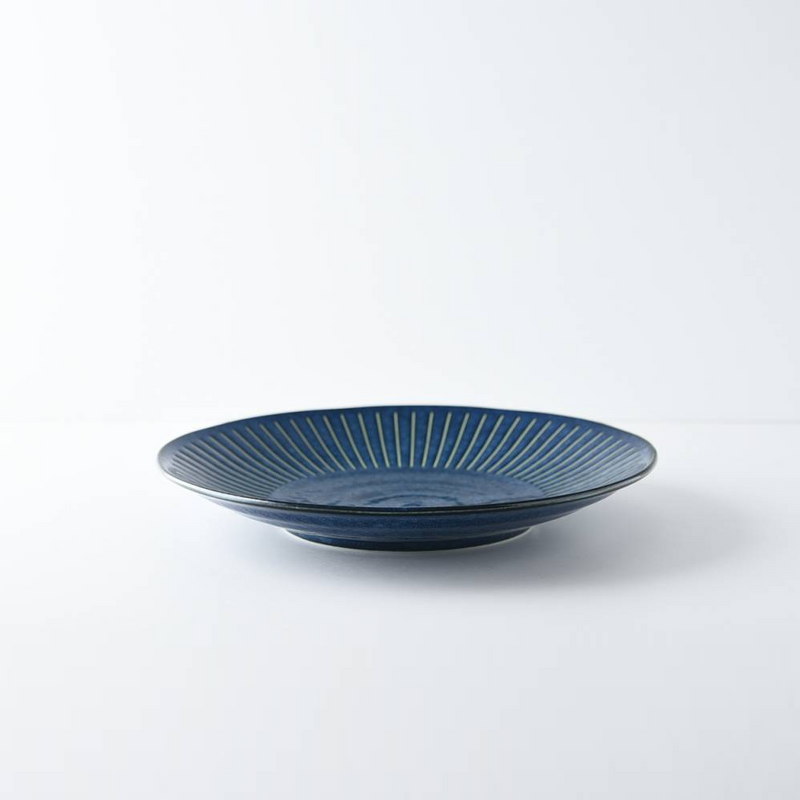 A side-profile view of the Tokusa Indigo Dinner Plate (23cm) on a white background, showing its shape and slightly raised rim.

