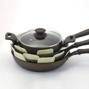 The retail packaging for a 3-pack of star-shaped Tortino cookware protective mats, showing the product in a clear bag.