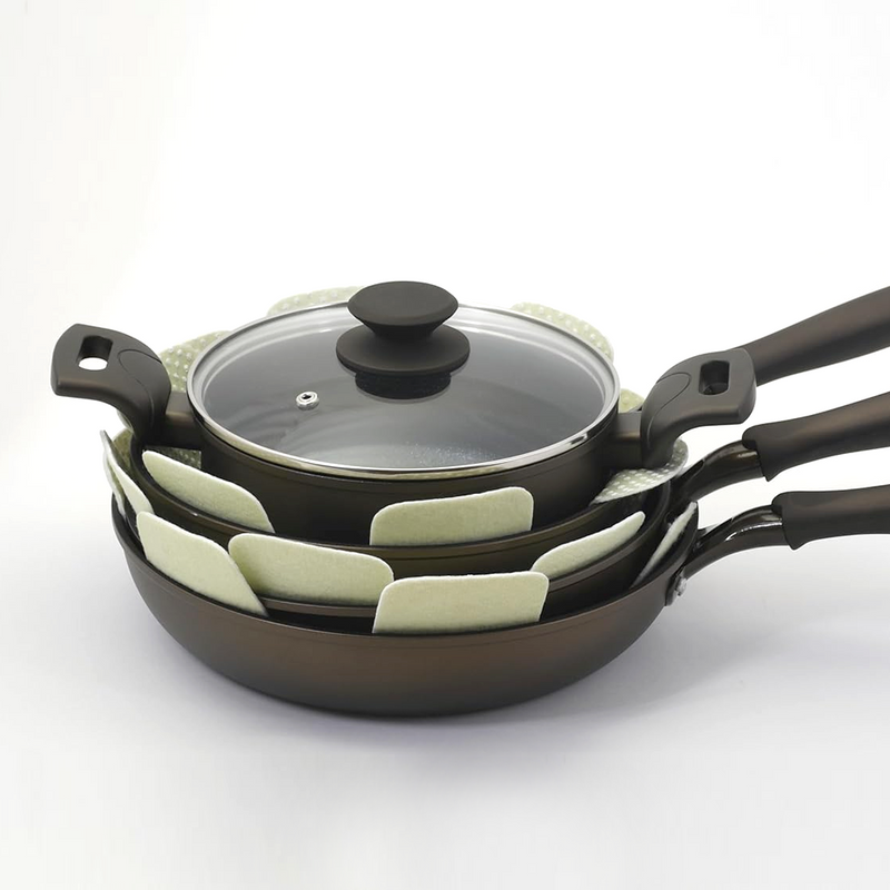 The retail packaging for a 3-pack of star-shaped Tortino cookware protective mats, showing the product in a clear bag.