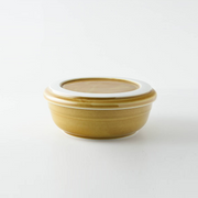 The Tripware Japan Bowl and Plate Set in a warm caramel glaze, with the plate functioning as a lid on the bowl.
