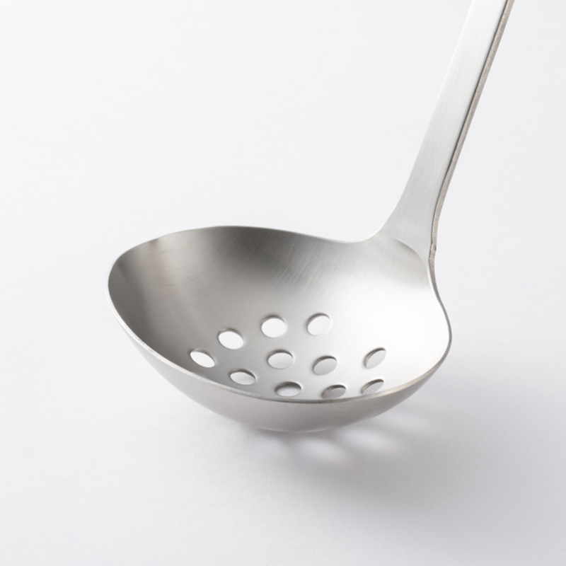 Close-up of Tsubame-Sanjo Stainless Steel Slotted Ladle with a polished finish and evenly spaced drainage holes.
