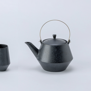 Yamatsu frustum japanese teacup in matte black with a modern angular design and textured finish.