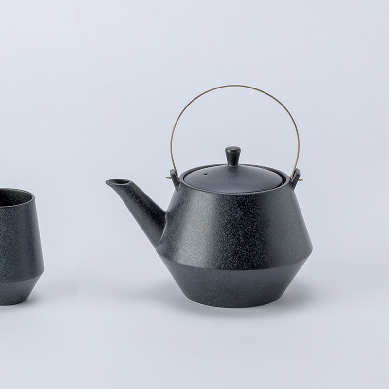 Yamatsu frustum japanese teacup in matte black with a modern angular design and textured finish.