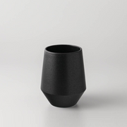 Yamatsu Frustum Japanese teacup in matte black finish, featuring a modern geometric silhouette with a conical base, set against a plain light grey background.






