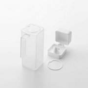 The Yamazaki Tower dispenser disassembled into its three parts—body, lid, and gasket—to show how it can be taken apart for easy cleaning.

