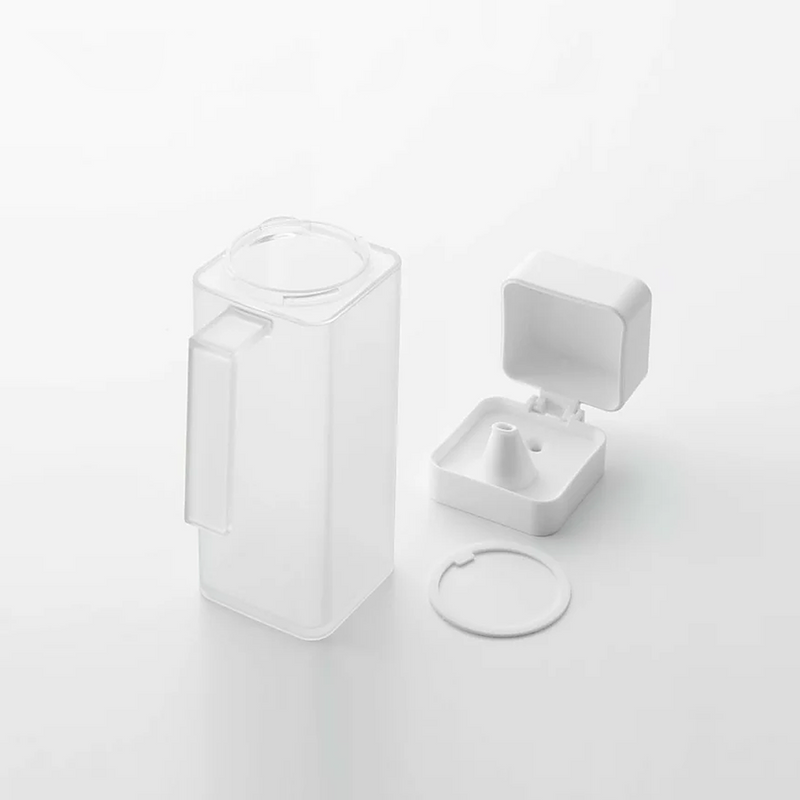 The Yamazaki Tower dispenser disassembled into its three parts—body, lid, and gasket—to show how it can be taken apart for easy cleaning.

