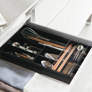 Yamazaki Tower expandable sliding cutlery tray in black, organising cutlery and chopsticks in a kitchen drawer