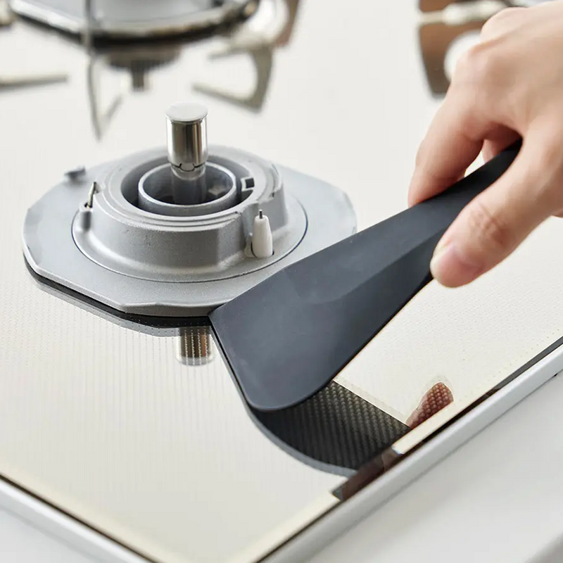 Person scraping batter from a glass bowl using the black Yamazaki scraper.

