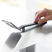 Yamazaki Tower Series Silicone Small Turner resting on a table with its head elevated to prevent surface contact.

