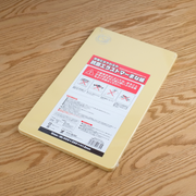 Yellow board with a label on a wooden surface