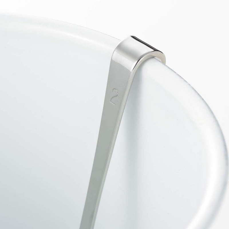 Close-up of the Yoshikawa spoon handle hooked securely onto the rim of a white container.