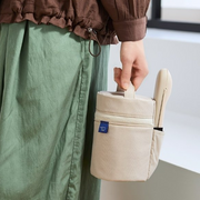 Zojirushi beige insulated food jar pouch with a side pocket holding a matching cutlery case (spoon and chopstick set).