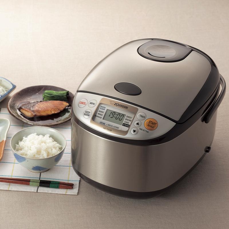 The Zojirushi MICOM Logic Rice Cooker 5.5 Cups shown as part of a traditional Japanese meal with grilled fish and fresh rice.

