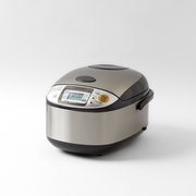 A studio product shot of the Zojirushi MICOM Logic Rice Cooker 5.5 Cups NS-TSQ10 on a white background.
