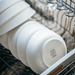 Close-up of Adam Liaw Everyday Noritake bowls and plates stacked in a dishwasher, showcasing their durability and dishwasher-safe quality.