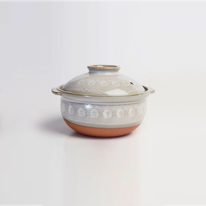 Side view of the Ginpo Hana Mishima Mini Donabe Japanese Clay Pot, showcasing the floral design on the grey exterior and the two small side handles.