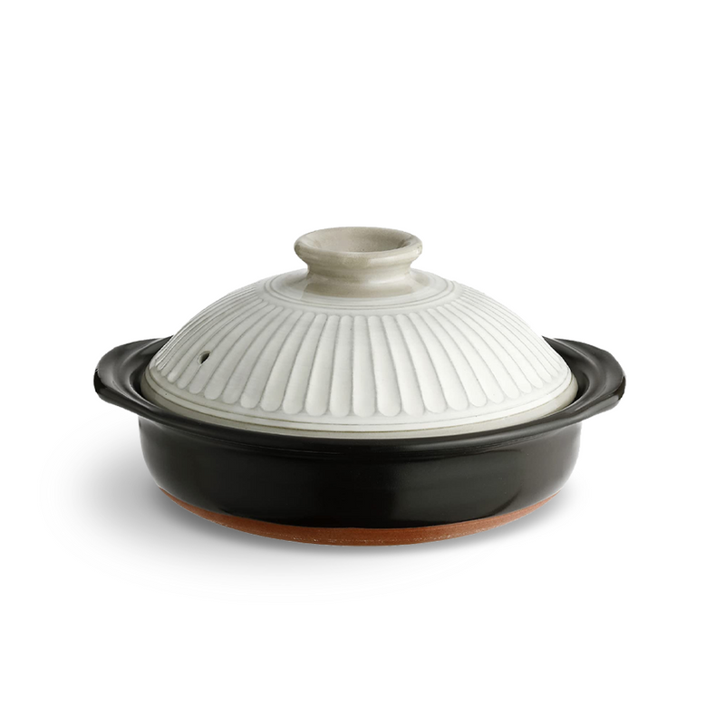 A large Japanese clay pot (donabe) featuring a deep black body and a grey-white lid with a textured chrysanthemum petal relief pattern.