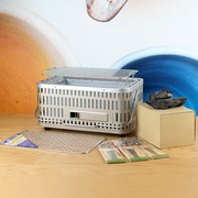 All the components of the Green Life Stainless Steel Konro Grill Starter Set, including the grill, two grill meshes, binchotan charcoal, and skewers.

