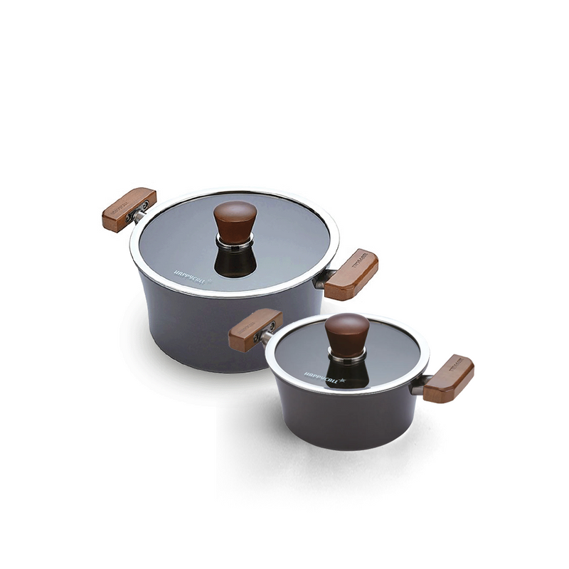 The Happycall Crocodile Graphene pot set, showing the 18cm and 24cm nonstick pots with their clear glass lids and vintage-style wood handles and knobs.