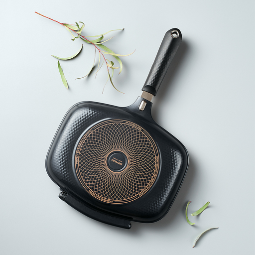 The closed Happycall IH Synchro Double Pan, angled to show the circular induction base on its textured grey exterior.