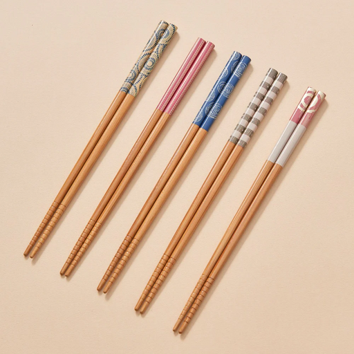 A studio photo of the Ishida Tennen Zai chopstick set, showing five pairs of natural bamboo chopsticks with assorted colourful patterned handles, displayed in their retail packaging.