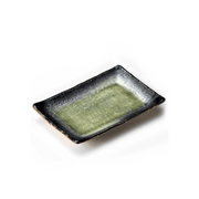 A studio photo of the Fukui Craft Ash Glaze Rectangular Serving Plate, highlighting its green crackled glaze center and contrasting dark textured rim, shown from an elevated angle.