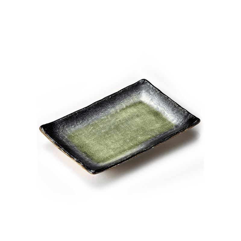 A studio photo of the Fukui Craft Ash Glaze Rectangular Serving Plate, highlighting its green crackled glaze center and contrasting dark textured rim, shown from an elevated angle.