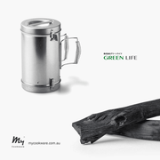 A promotional image for MyCookware Australia featuring the Green Life 2-in-1 Charcoal Chimney and Extinguisher alongside two pieces of Binchotan charcoal.
