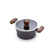 The 18cm Happycall Crocodile Graphene nonstick induction pot with its matching dark glass lid, featuring wood-style handles and knob, angled on a white background.
