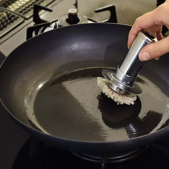 Ichibishi Stainless Steel Oil Basting Set: brushing oil in a carbon steel wok