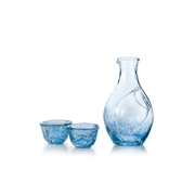 The Toyo Sasaki handmade blue glass sake set, featuring a textured carafe with an ice pocket and two matching small cups, shown against a white background.
