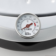 A close-up macro shot of the integrated thermometer on the Yoshikawa deep fryer, displaying temperature markings in Celsius for precise oil control.
