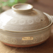 Close-up of Ginpo Hana Mishima Donabe Clay Pot, emphasizing the floral patterns and the brand's stamped logo on its side.